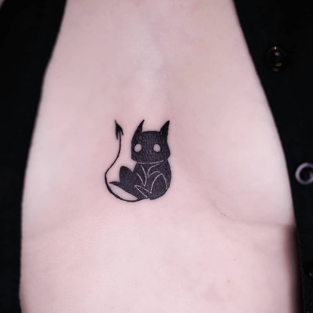 Charming chest tattoo of a playful cat Tattoo Design