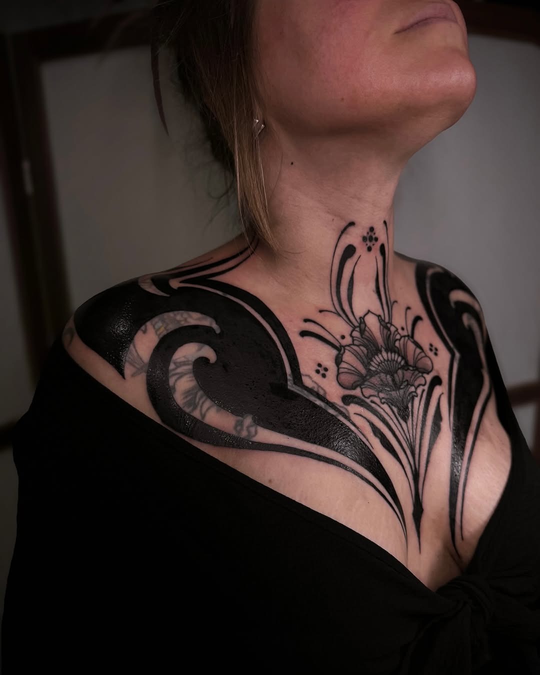 Elegant black floral chest tattoo design Tattoo Design