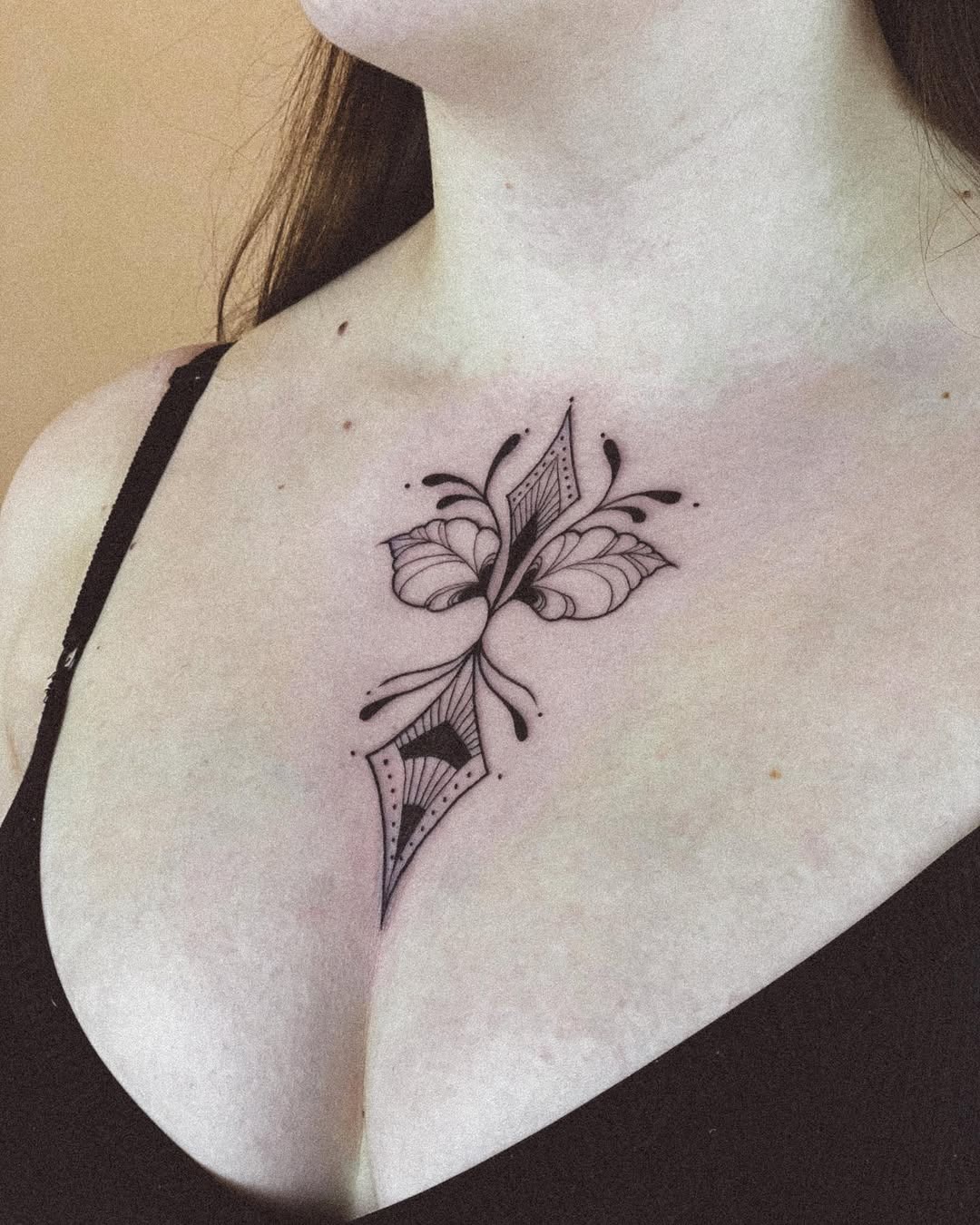 Elegant butterfly tattoo gracing the chest. Tattoo Design