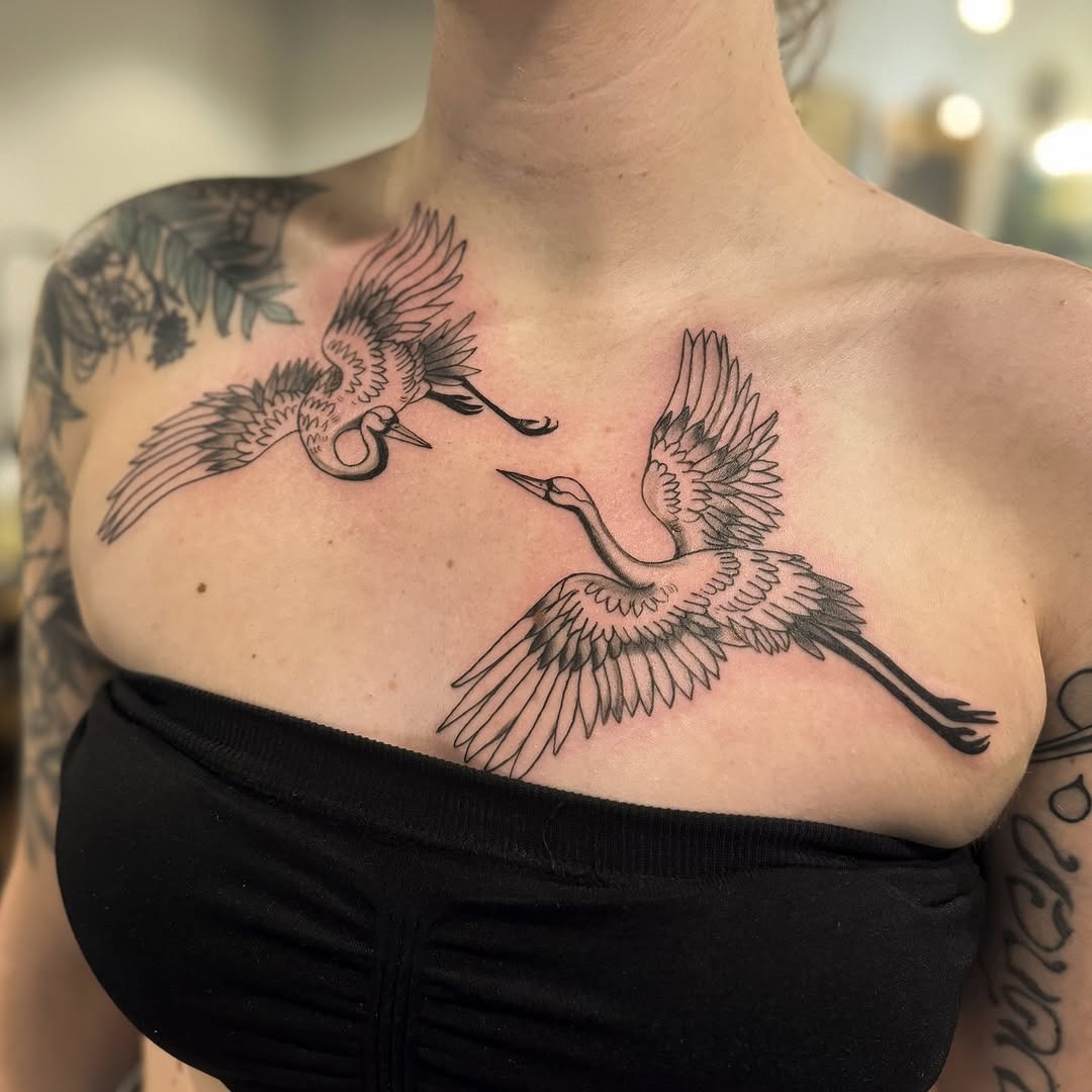 Elegant cranes soaring across the chest Tattoo Design