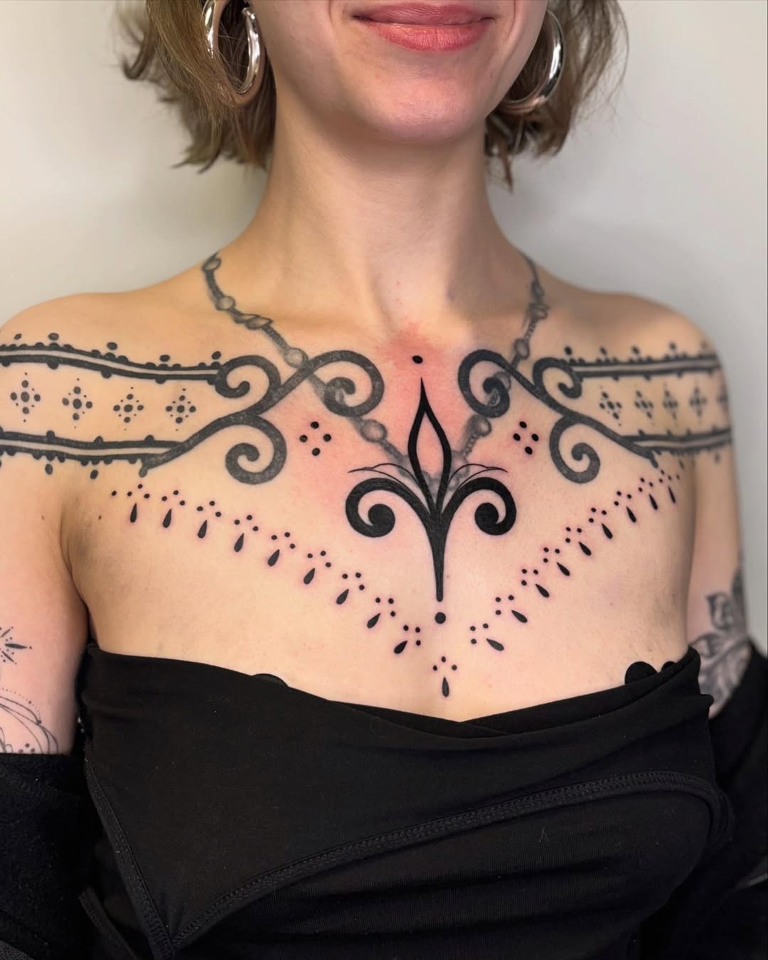 Intricate Chest Tattoo with Elegant Patterns Tattoo Design