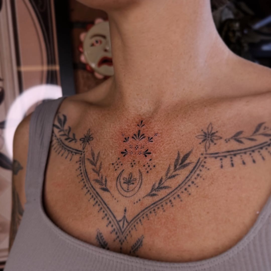 Intricate floral patterns grace the chest Tattoo Design