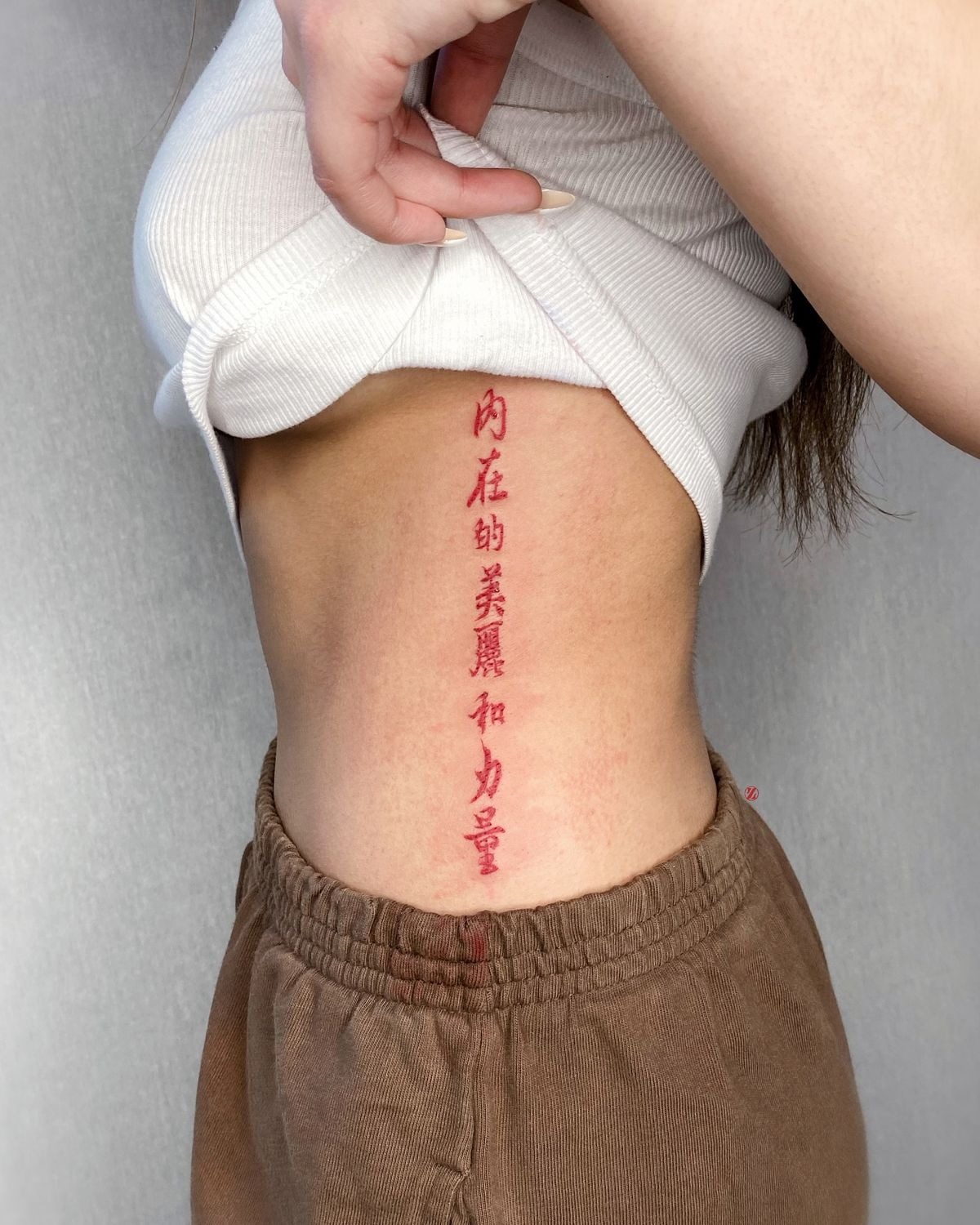 Vertical Red Rib Script Tattoo Tattoo Design