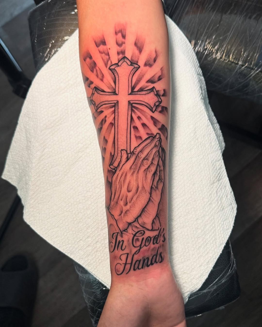 Faith symbolized through prayerful hands and cross Tattoo Design