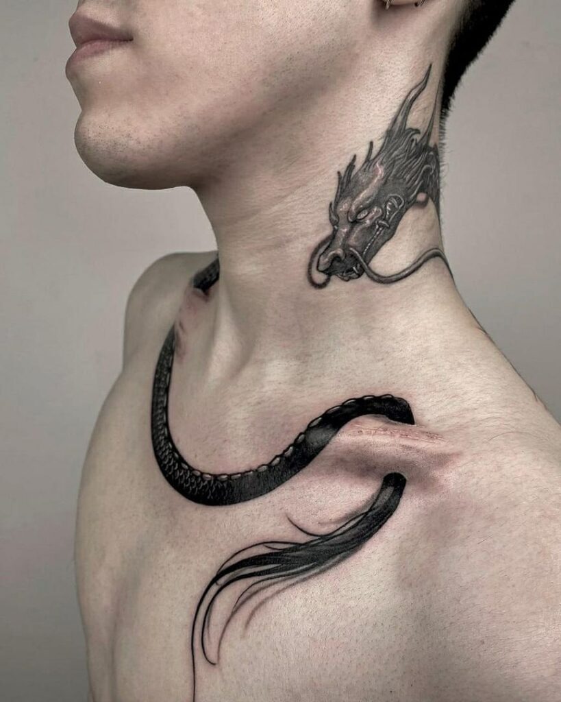 A bold and striking dragon tattoo wrapping from the neck to the collarbone with intricate detailing.