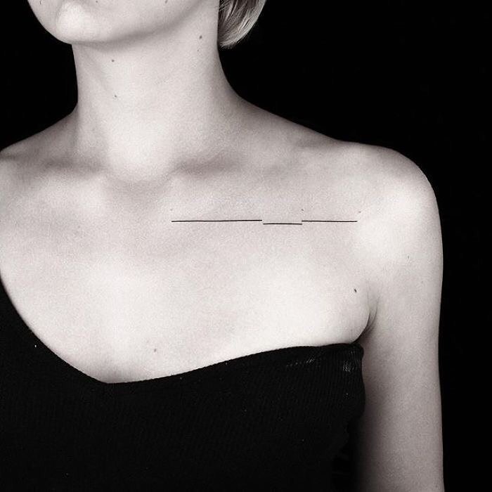 A sleek and simple tattoo featuring a straight line subtly placed along the collarbone.