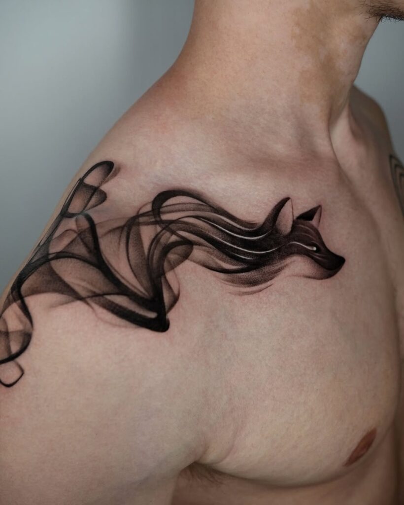 A bold and captivating collarbone tattoo featuring a wolf rendered in a mesmerizing smoke effect.