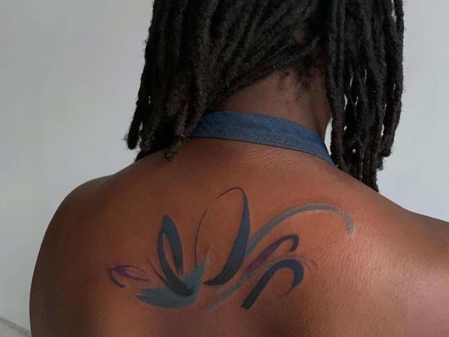 Neck Tattoo with Fruit and Floral Motif tattoo design