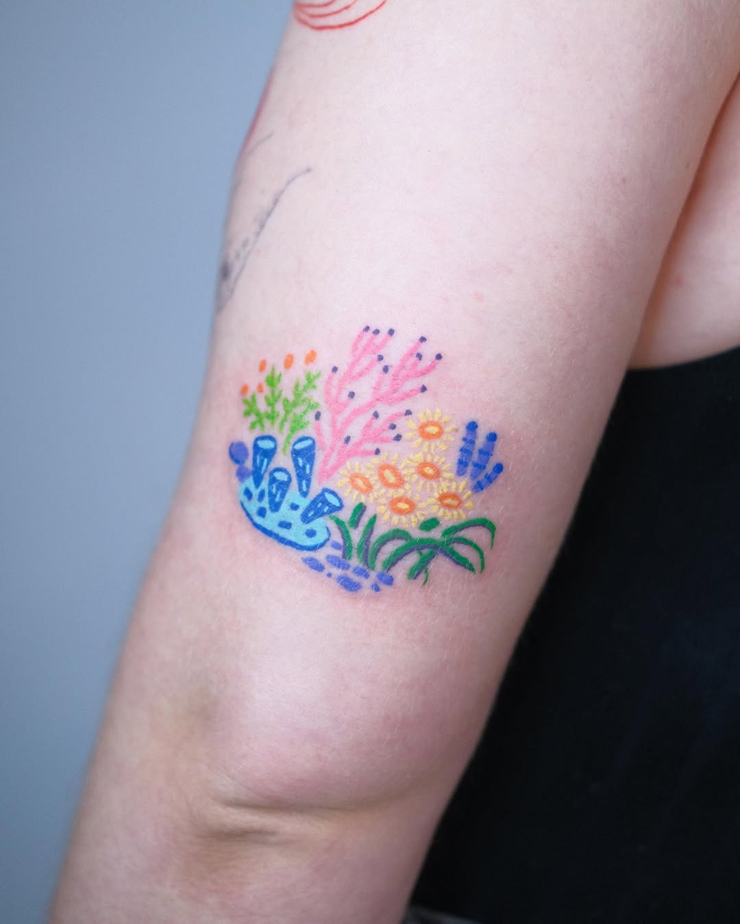 A colorful coral reef tattoo with playful elements Tattoo Design