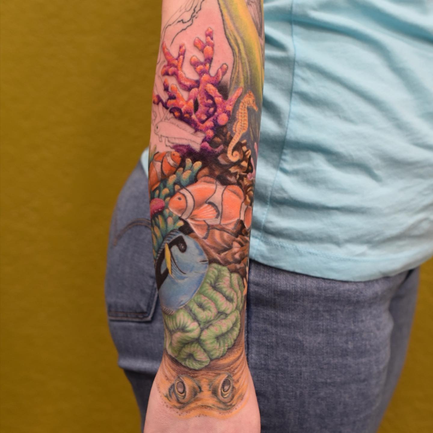 Colorful coral reef tattoo wraps around forearm Tattoo Design
