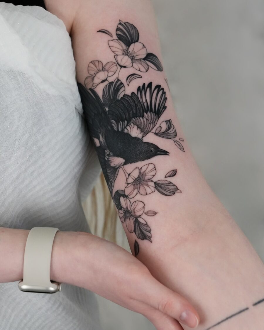 Elegant bird tattoo with floral elements Tattoo Design