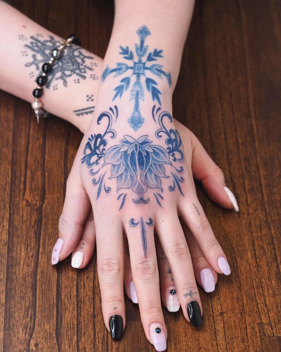 Elegant floral and cross tattoo design on hand Tattoo Design