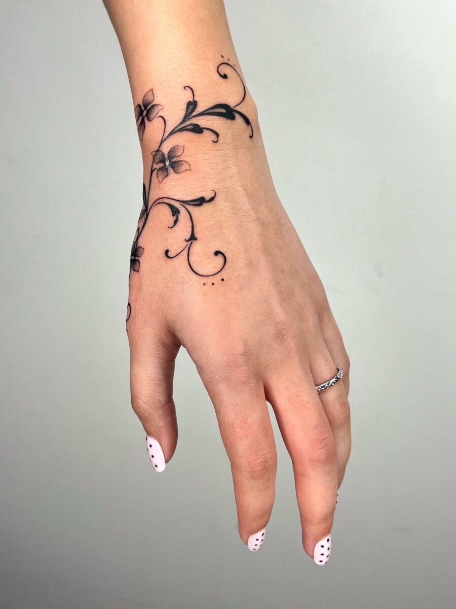 Elegant floral tattoo design on the hand Tattoo Design