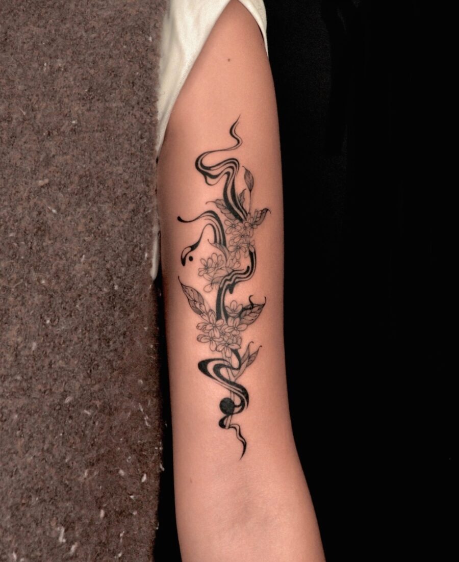 Elegant floral tattoo with flowing designs. Tattoo Design