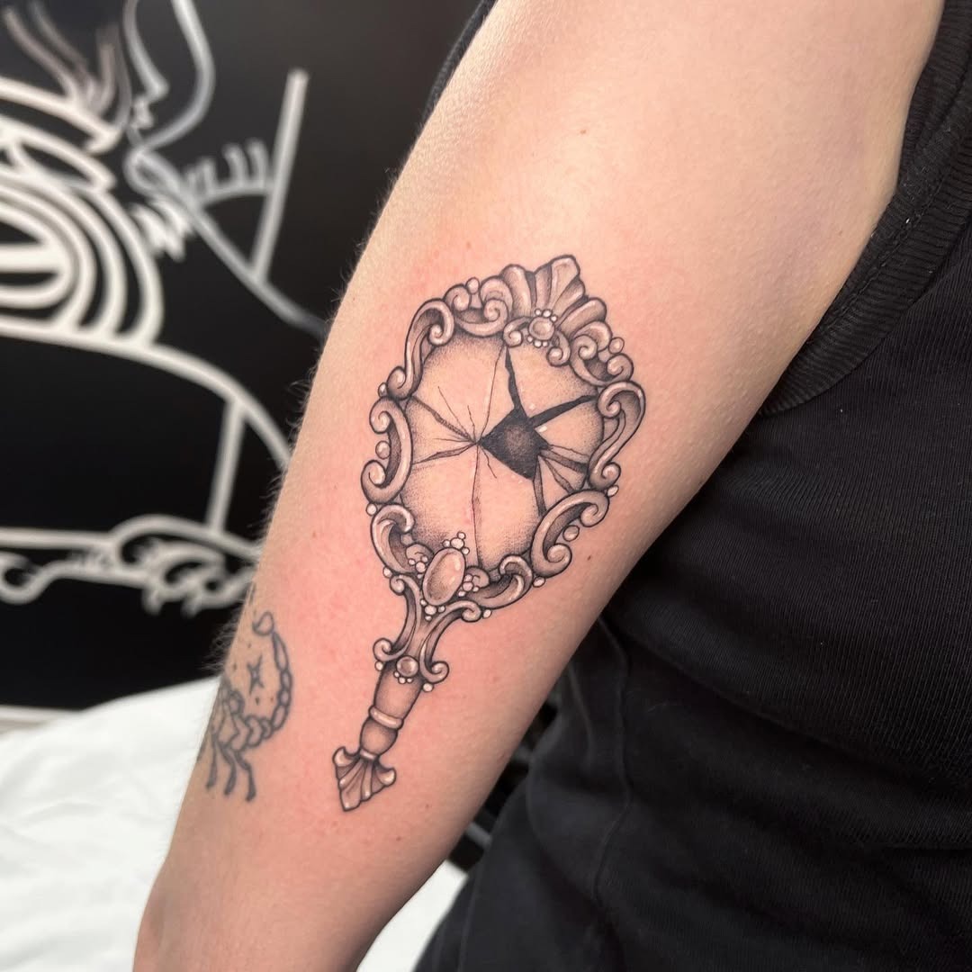 Elegant cracked mirror tattoo showcasing intricate details Tattoo Design