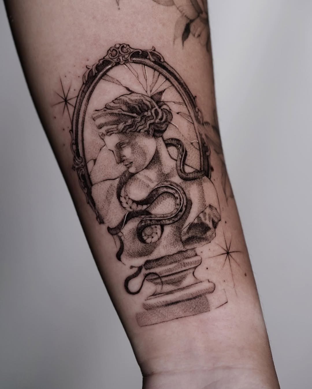 Elegant cracked mirror tattoo with mythological bust Tattoo Design