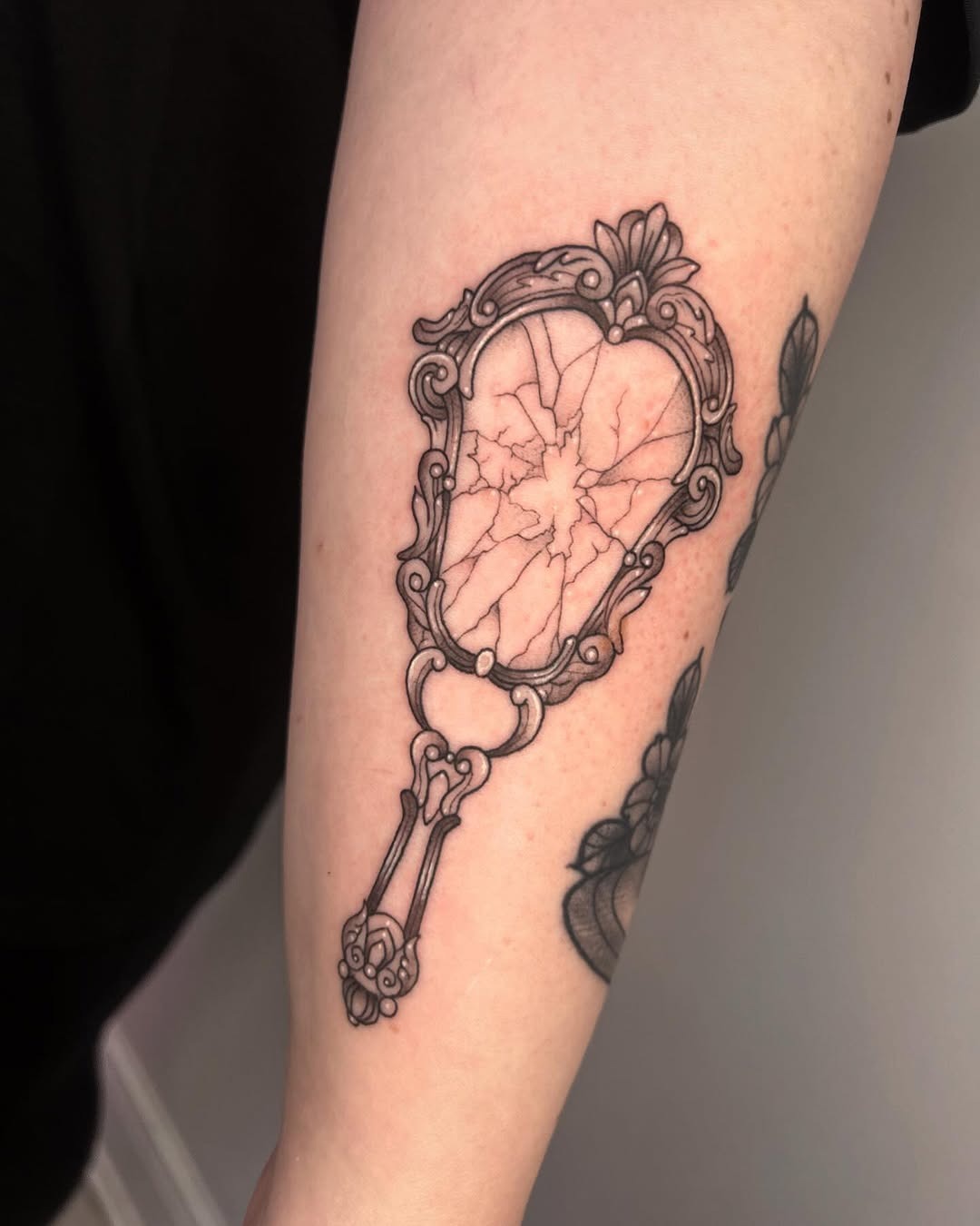Intricate cracked mirror tattoo design on arm Tattoo Design