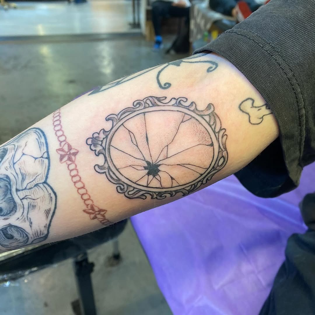 Intricate cracked mirror tattoo design on forearm Tattoo Design