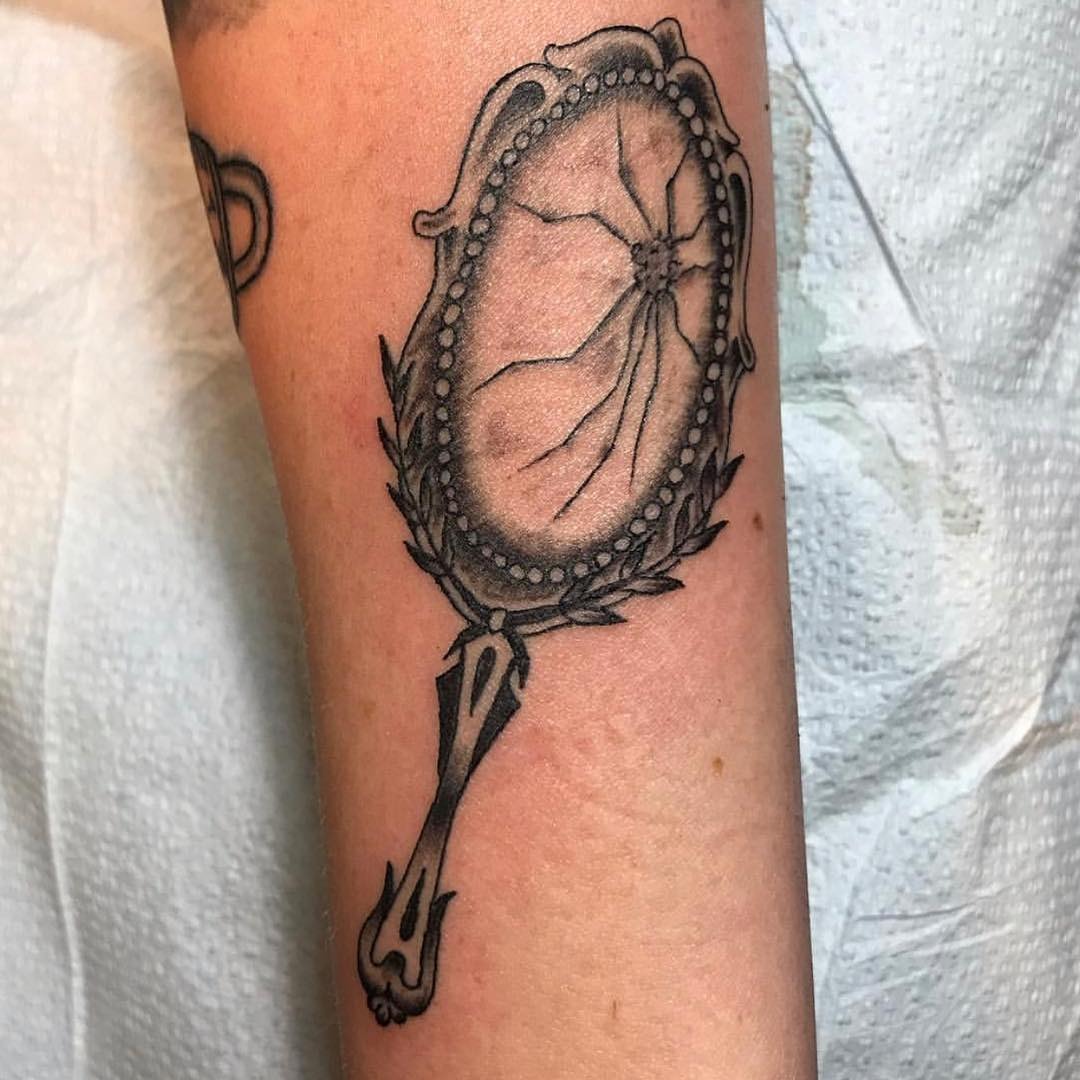Intricate cracked mirror tattoo with vintage flair Tattoo Design