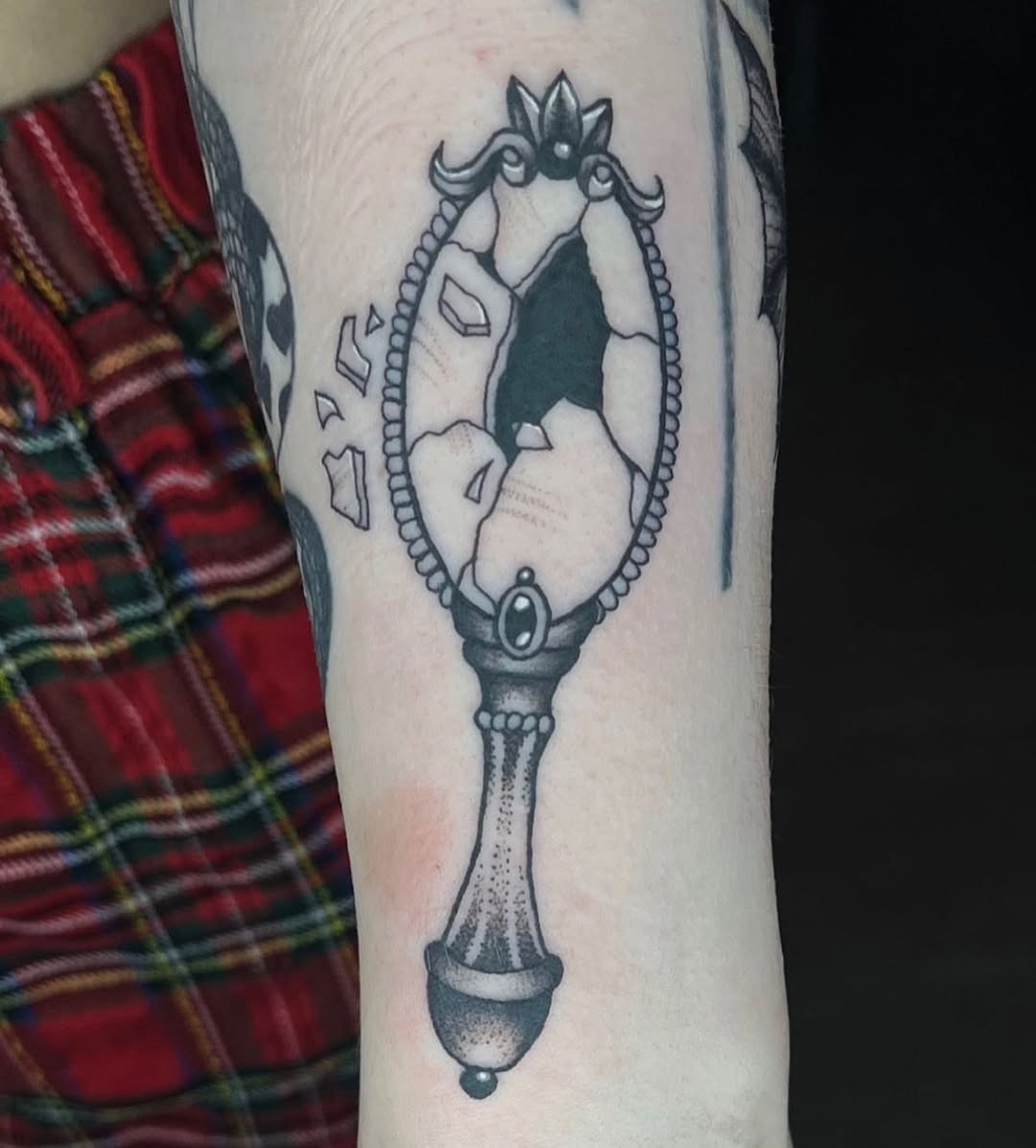 Unique cracked mirror tattoo design on arm Tattoo Design