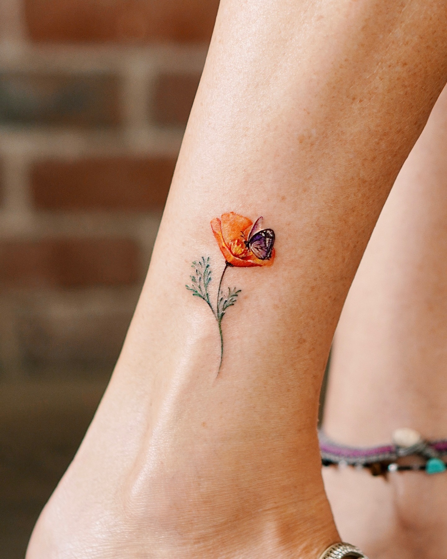 Butterfly on Poppy Flower Tattoo Tattoo Design