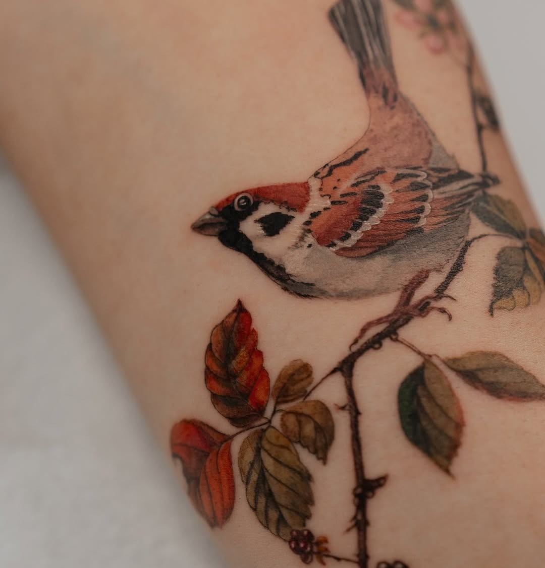 Charming Sparrow Amidst Blossoming Leaves Tattoo Design