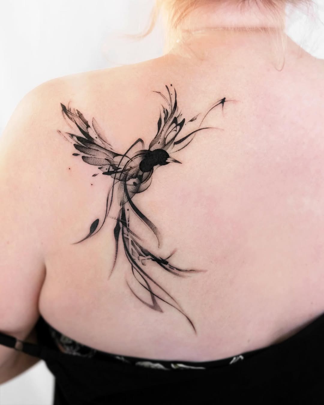 Elegant bird tattoo gracefully adorns the back Tattoo Design