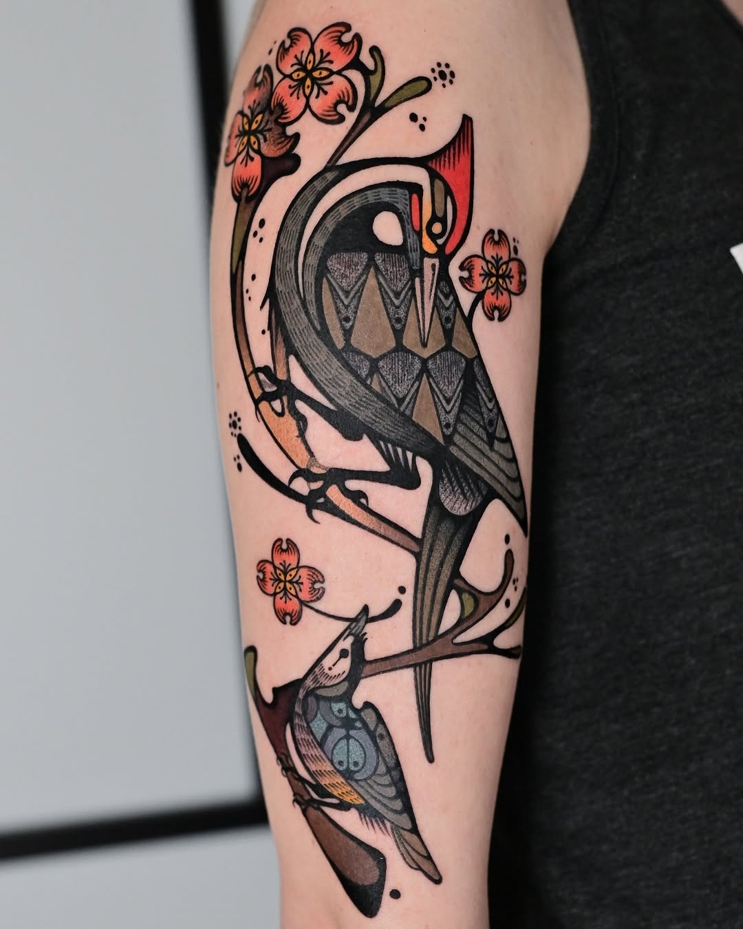 Elegant birds perched on blossoming branches Tattoo Design