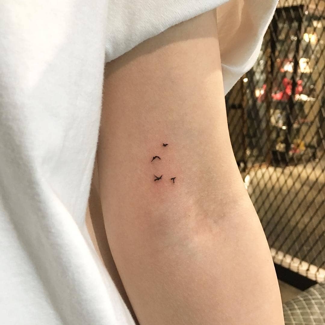 Elegant minimalist bird tattoo in flight Tattoo Design