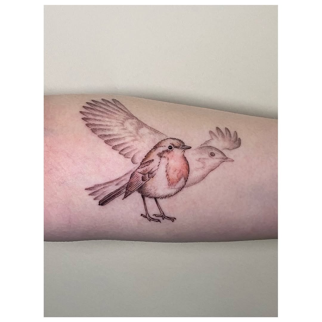 Whimsical bird tattoo in flight Tattoo Design
