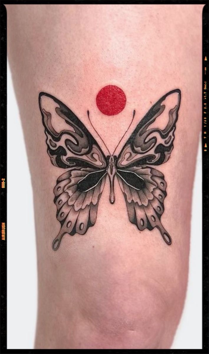 Artistic Butterfly with Red Sun Tattoo, a tattoo design rendered in bold for the leg.