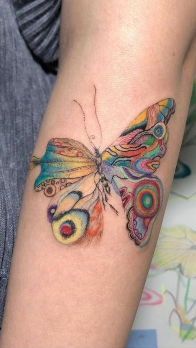 Colorful Artistic Butterfly Arm Tattoo, a tattoo design rendered in bold traditional.
