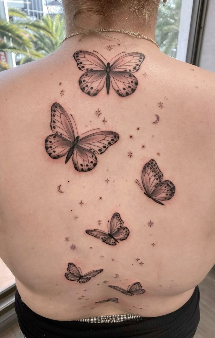 Full Back Butterfly and Stars Tattoo, a tattoo design rendered in clean detailed linework.