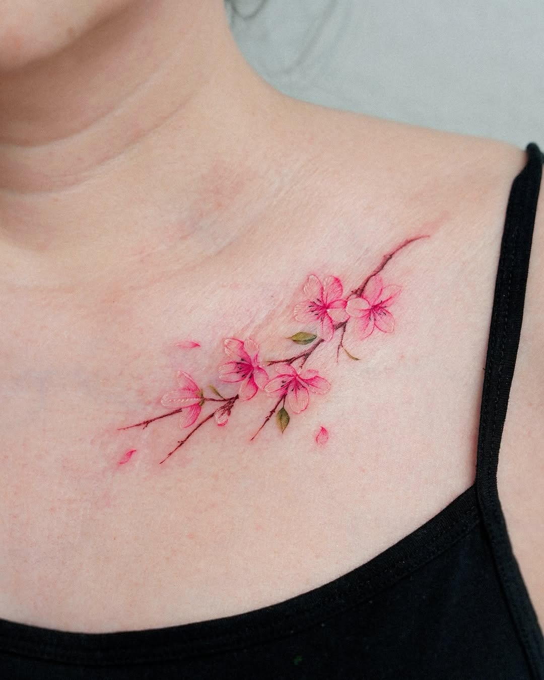 Delicate cherry blossom tattoo on collarbone Tattoo Design