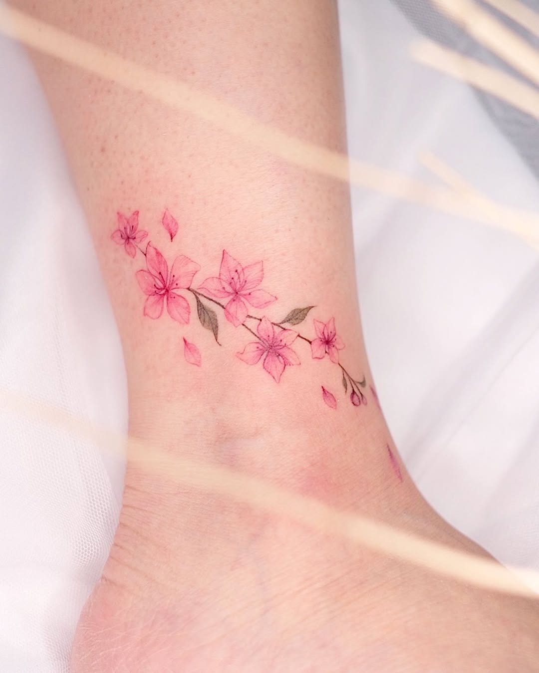 Delicate cherry blossom tattoo on the ankle Tattoo Design