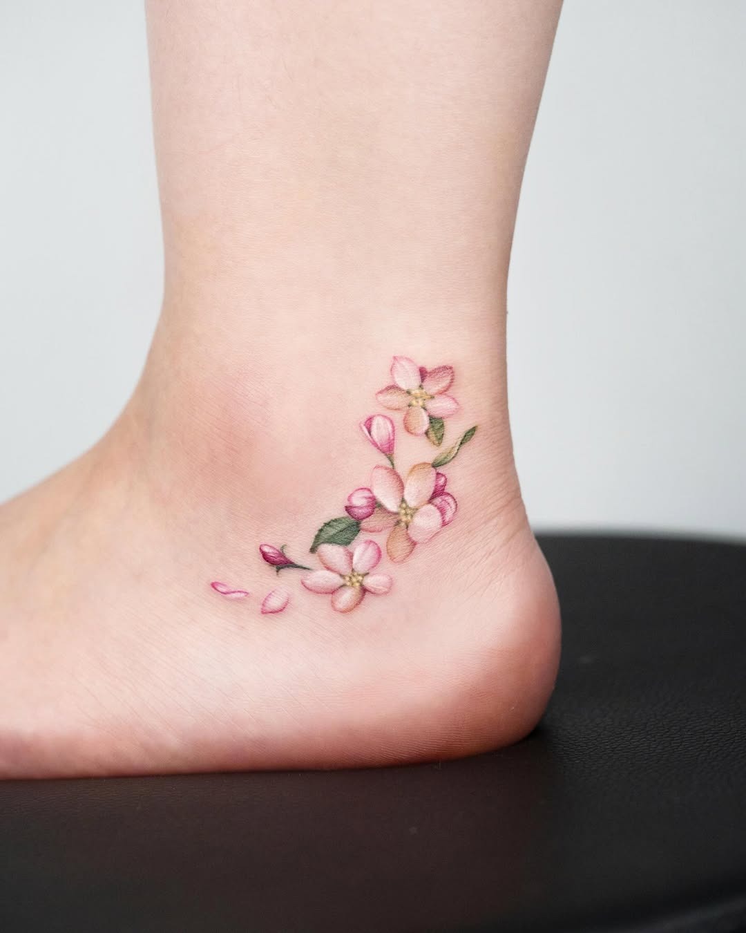 Delicate cherry blossoms adorn the ankle beautifully. Tattoo Design