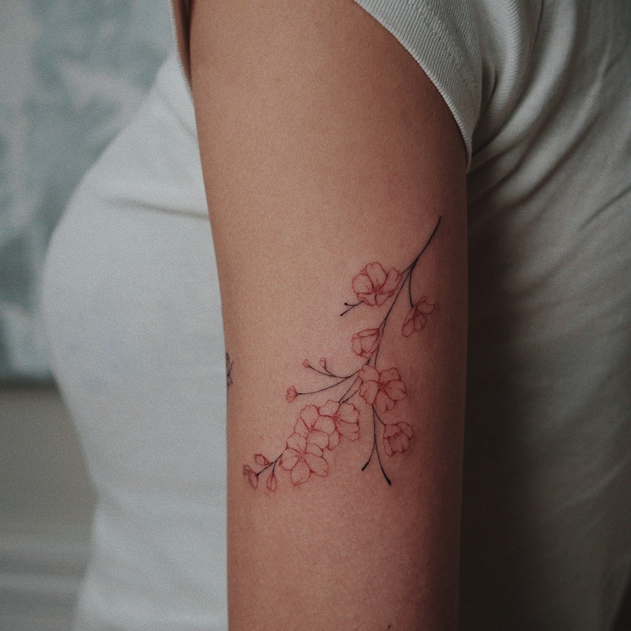 Delicate Cherry Blossoms Adorning the Arm Tattoo Design