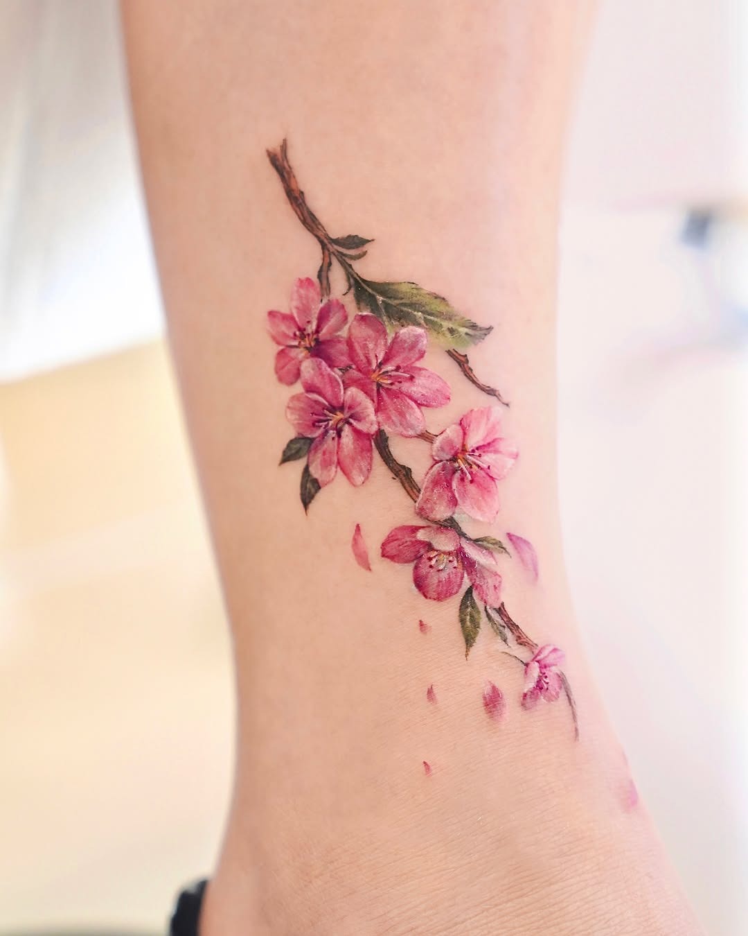 Elegant cherry blossom branch tattoo design on ankle Tattoo Design