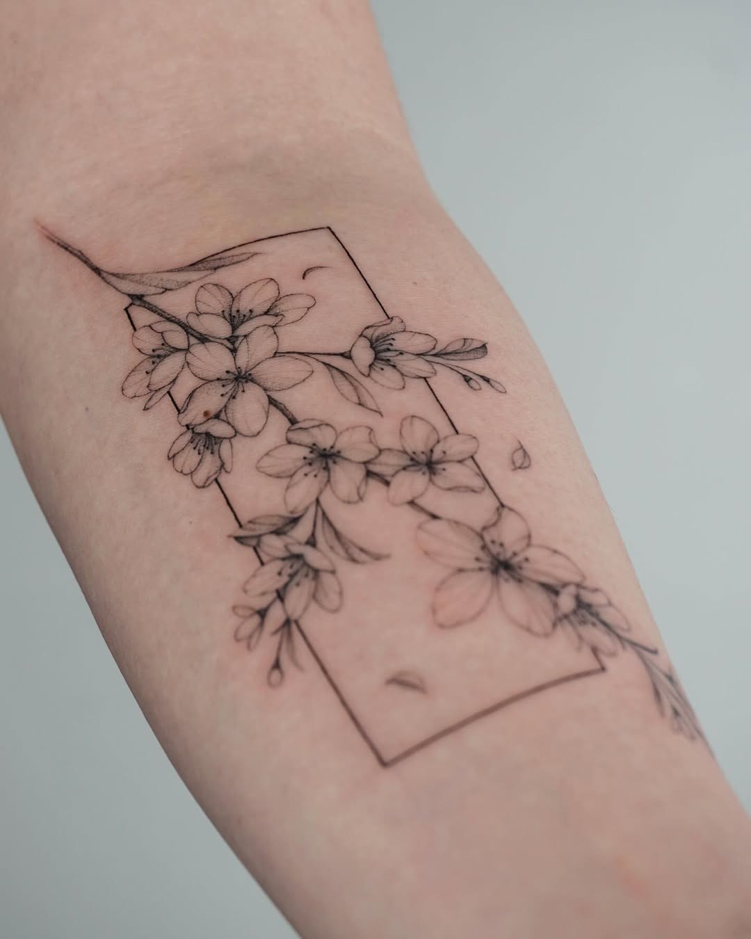 Elegant cherry blossom tattoo in minimalistic style Tattoo Design