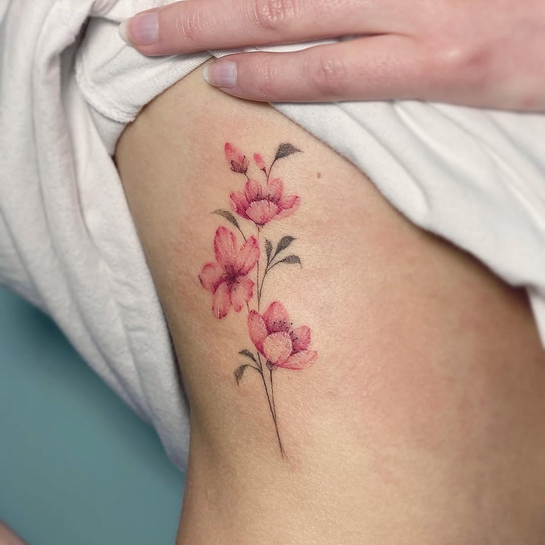 Elegant cherry blossom tattoo on soft skin Tattoo Design