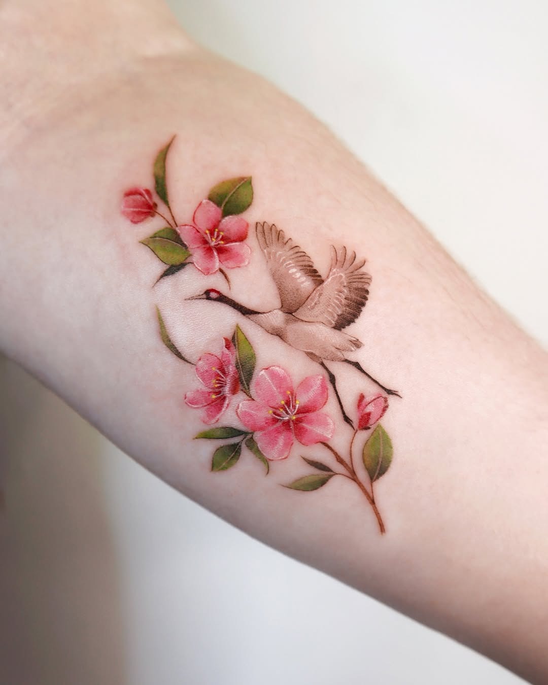 Elegant cherry blossom tattoo with a flying bird Tattoo Design