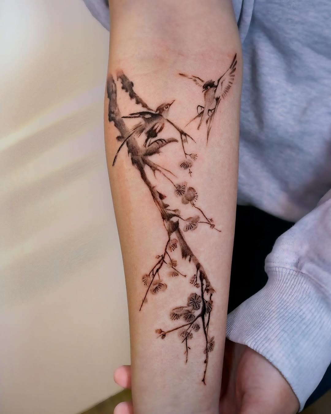 Elegant cherry blossom tattoo with bird design Tattoo Design