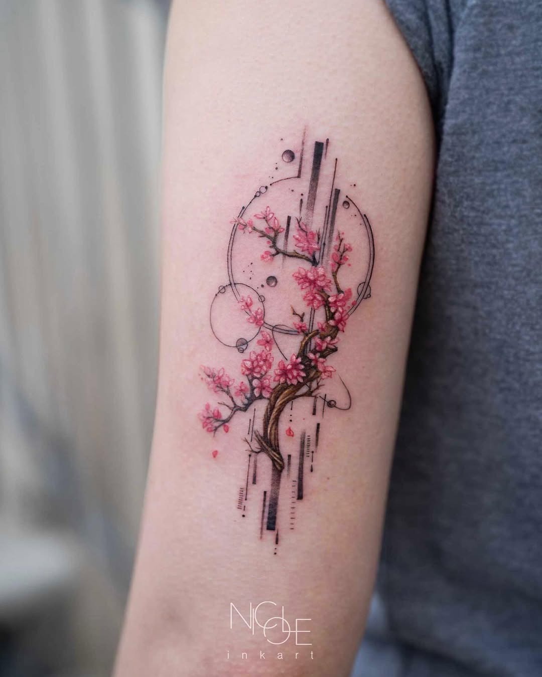 Elegant cherry blossom tattoo with modern elements Tattoo Design
