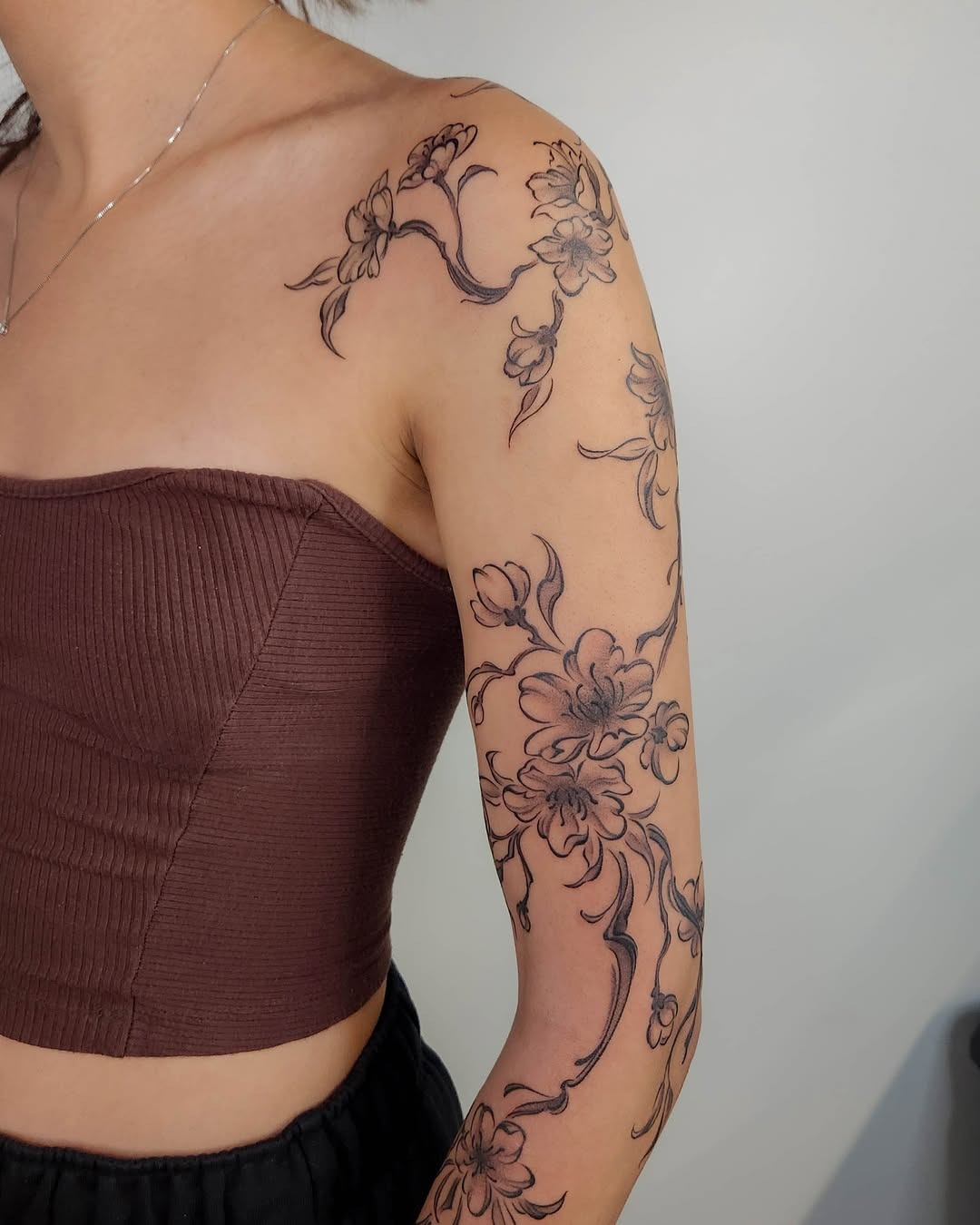 Elegant cherry blossoms wrapping beautifully around the arm Tattoo Design