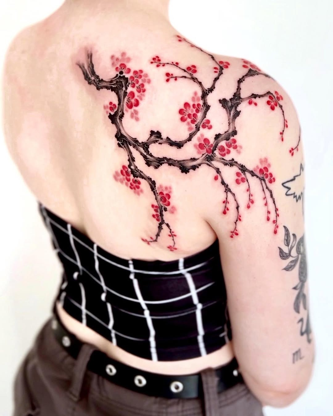 Stunning cherry blossom tattoo on the back Tattoo Design
