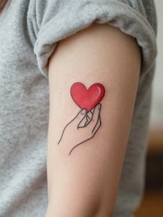 Hand-Holding Red Heart Tattoo Tattoo Design