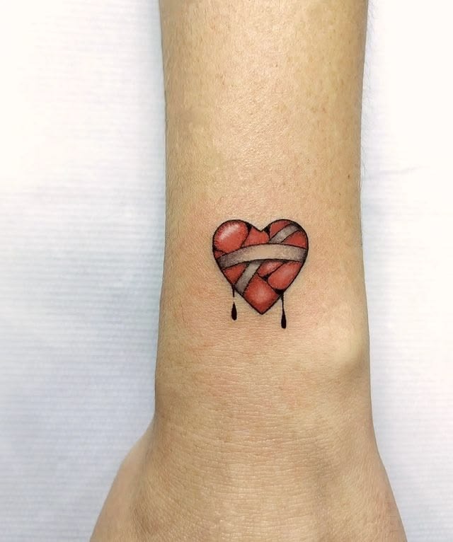 Tiny Bandaged Red Heart Tattoo Tattoo Design