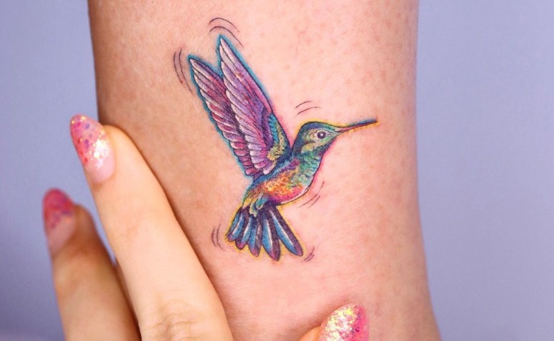 Cartoon-Style Rainbow Hummingbird Tattoo Thrumming with Motion Tattoo Design