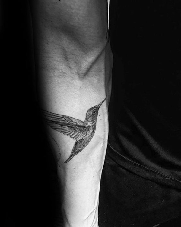 Intricately Detailed Fluttering Hummingbird Tattoo on Arm Tattoo Design