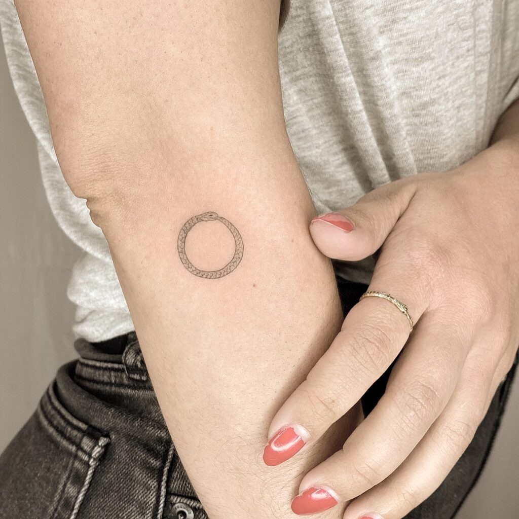 Tiny Ouroboros Tattoo on Inner Arm Tattoo Design